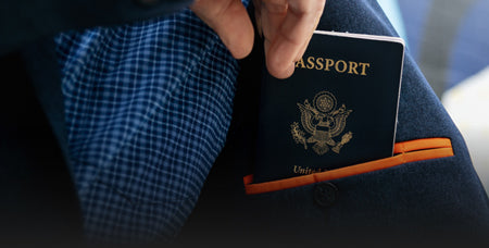 A closeup of a passport coming out of a travel pocket in our blazer.