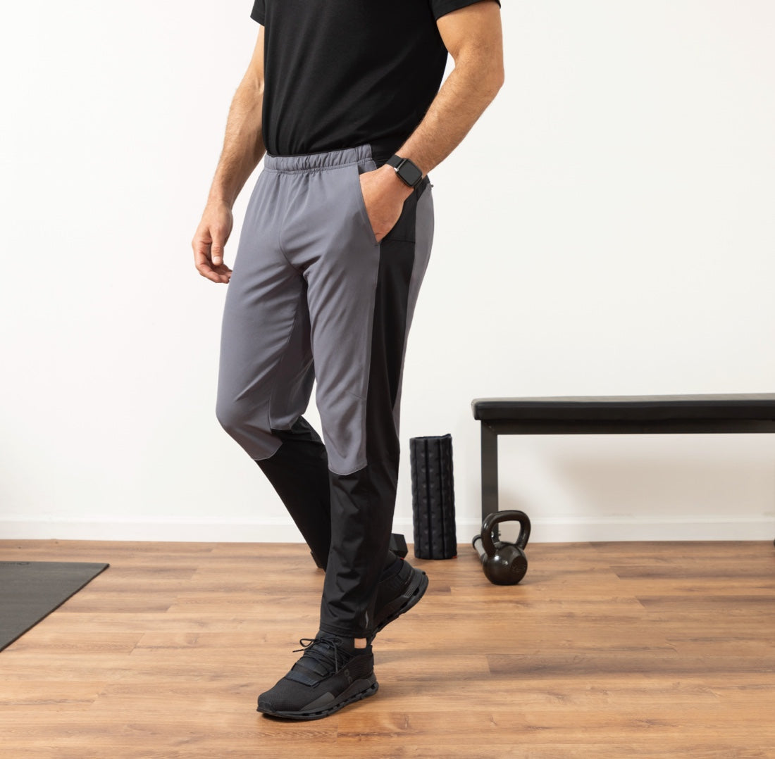 Model wears Rev Pants in Pavement Grey in a workout setting.