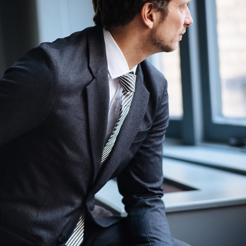 Stefan, the founder of Bluffworks, wears the Gramercy Blazer in Blue Hour in an office setting.