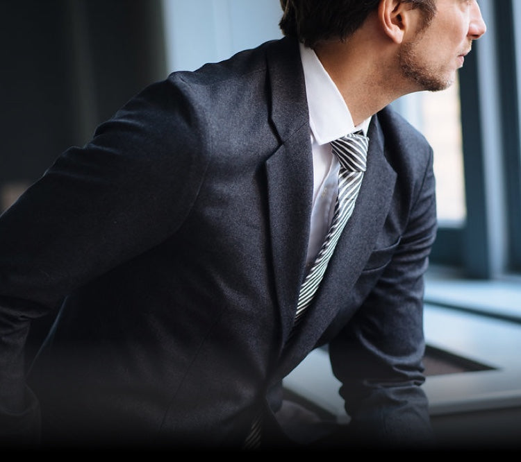 Stefan, the founder of Bluffworks, wears the Gramercy Blazer in Blue Hour in an office setting.