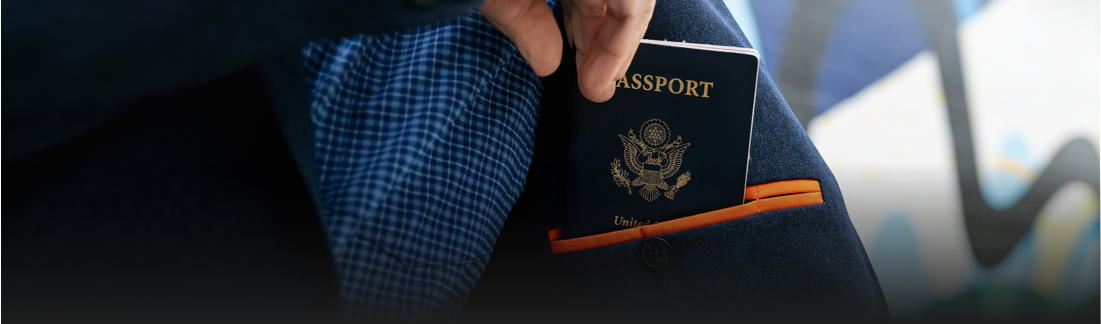 A closeup of a passport coming out of a travel pocket in our blazer.